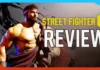 A muscular male fighter with a red headband is shown next to the words “Street Fighter 6 Review” in bold text on a stylized background.